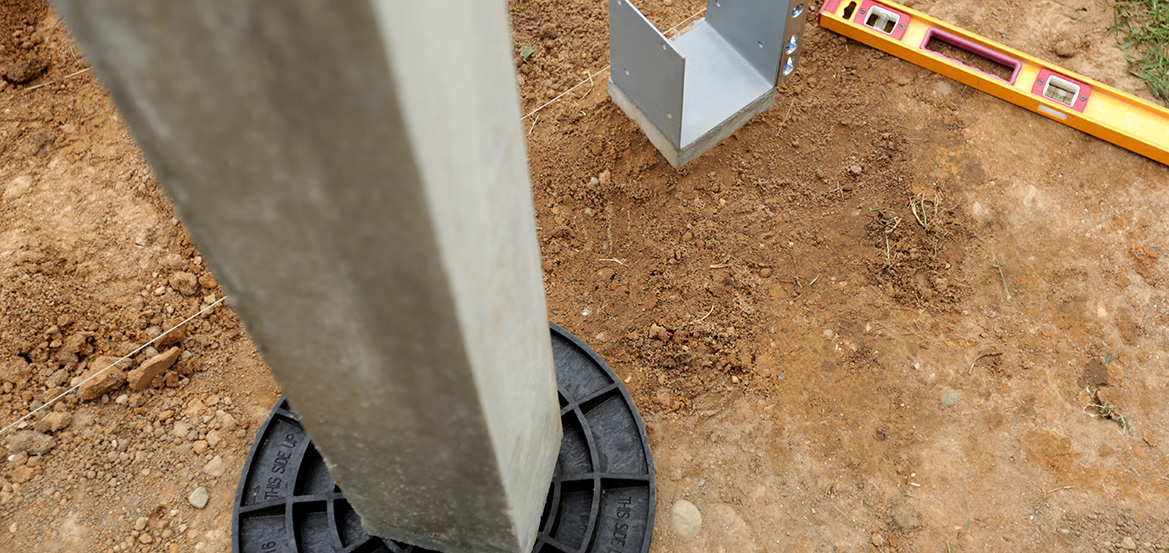 Deck post with footing pad